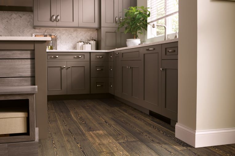 dark hardwood flooring in a charming kitchen with dark cabinets